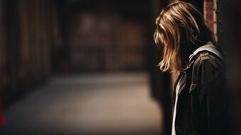 Woman with her head bowed