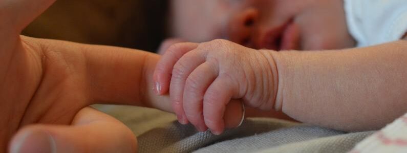 Baby holding mothers hand 6 0