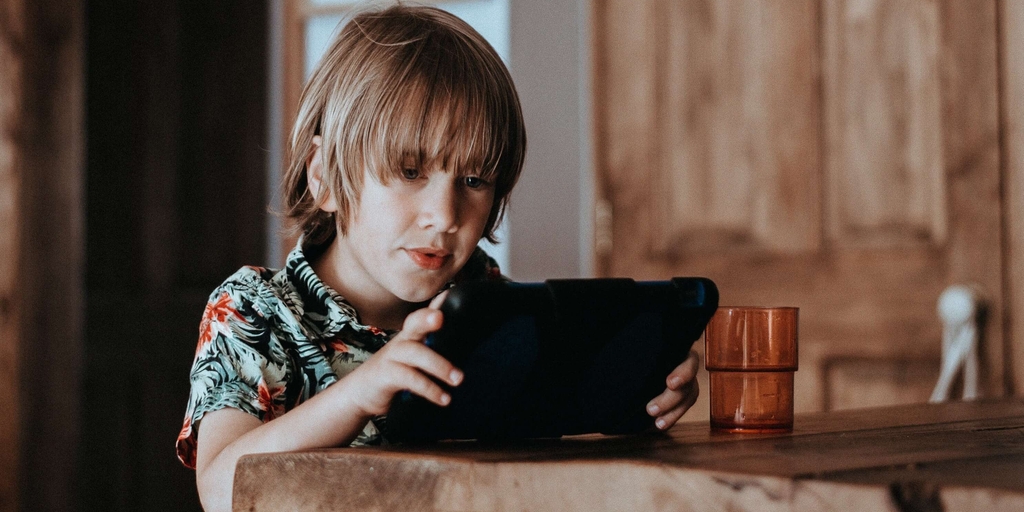 Young boy plays with ipad