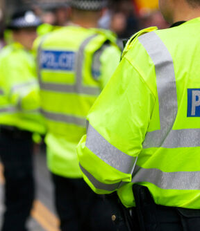 Police officers in high-viz jackets policing a demonstration