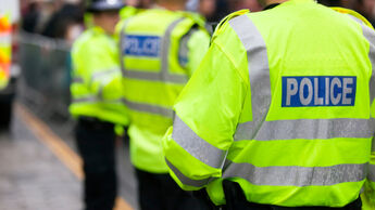 Police officers in high-viz jackets policing a demonstration