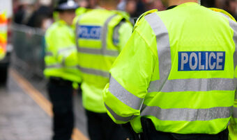 Police officers in high-viz jackets policing a demonstration