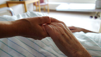 Holding the hand of patient