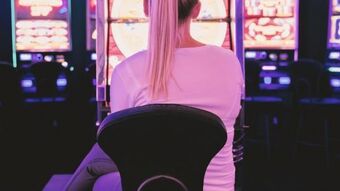 Female sat in front of gambling machines nu