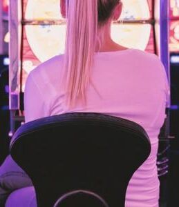 Female sat in front of gambling machines nu