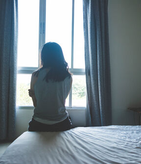 Woman looking out window trafficking