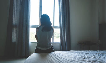 Woman looking out window trafficking