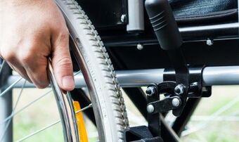 Wheelchair and hand shutterstock 177634730 0