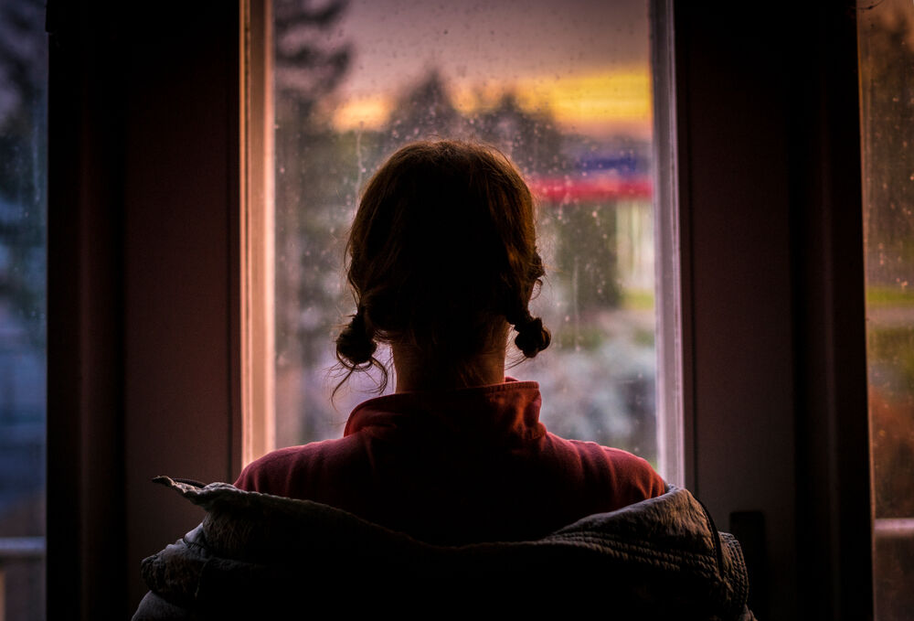 Woman looking out window silhouette exploitation small