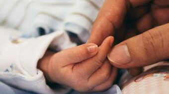 Mother baby touching hands 8