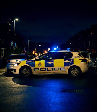 Police car nighttime protest unrest