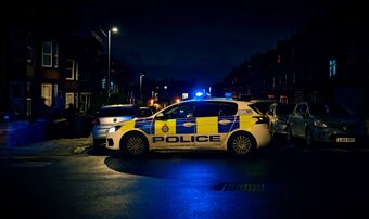 Police car nighttime protest unrest