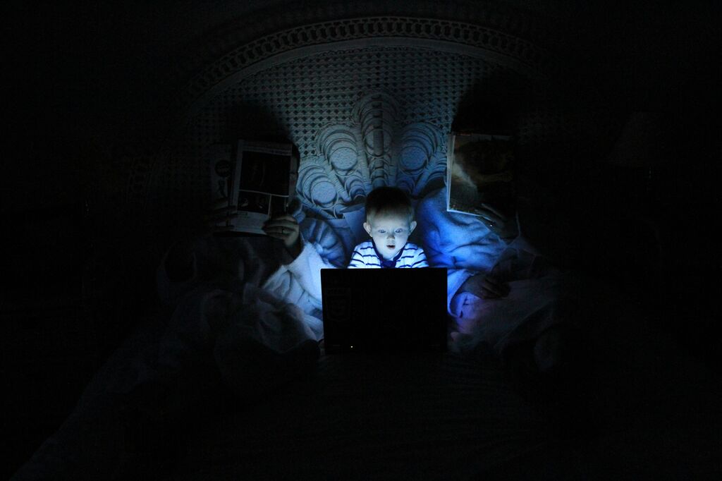 Child on computer in darkness