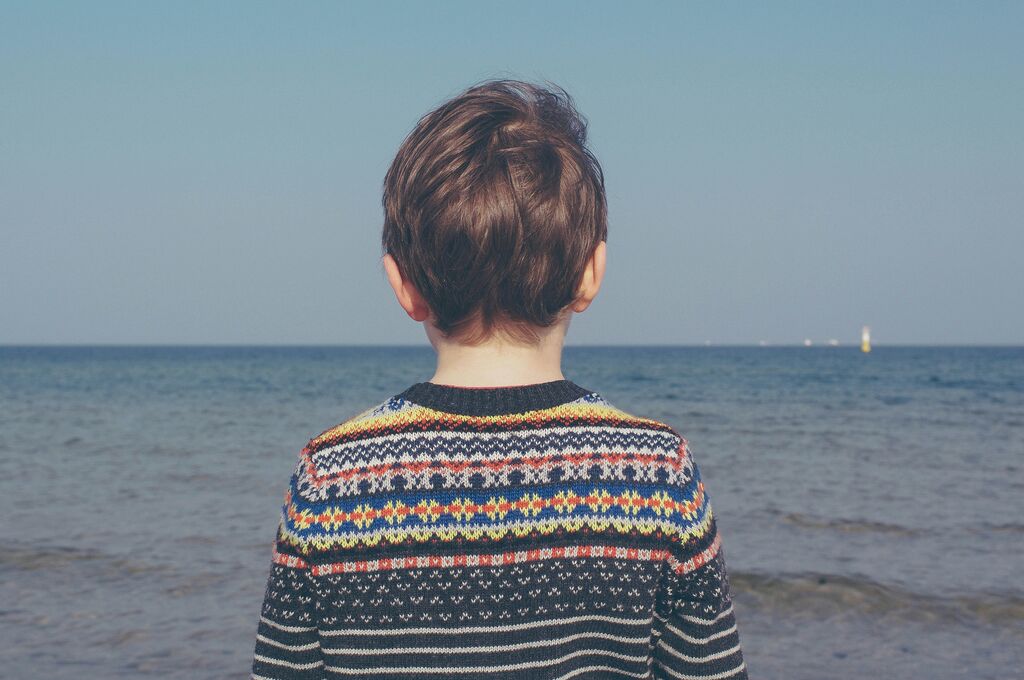 Boy looking out into ocean