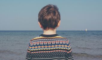 Boy looking out into ocean