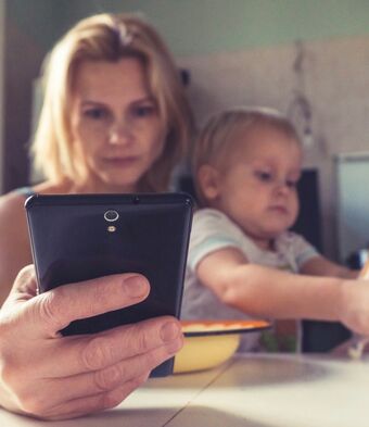 Woman on phone with kids