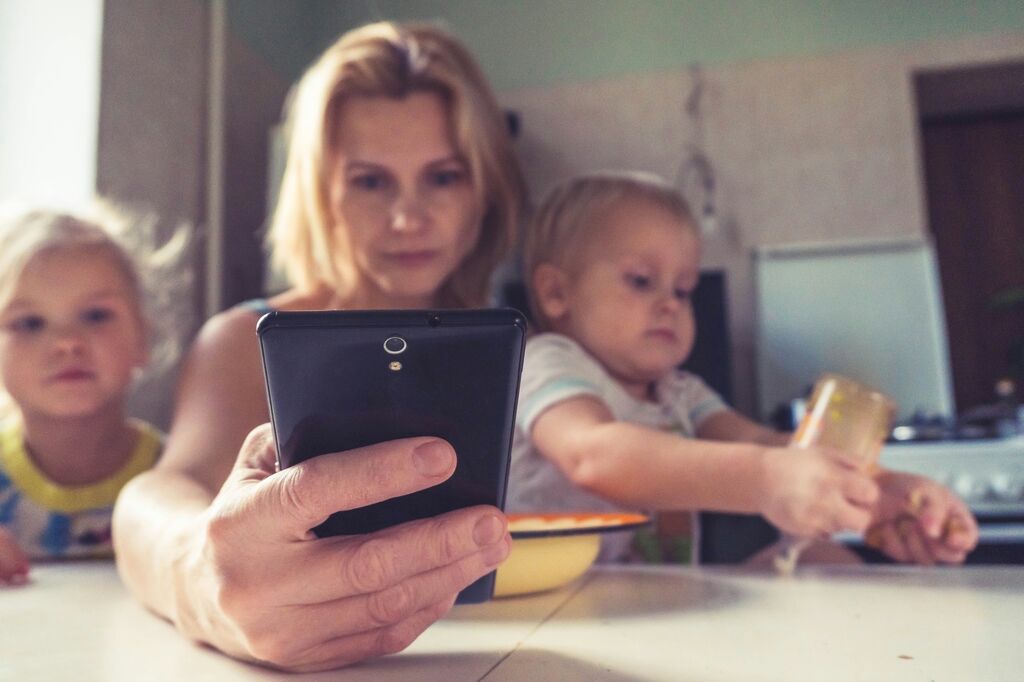 Woman on phone with kids
