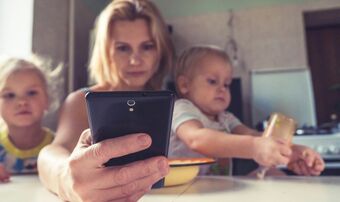 Woman on phone with kids