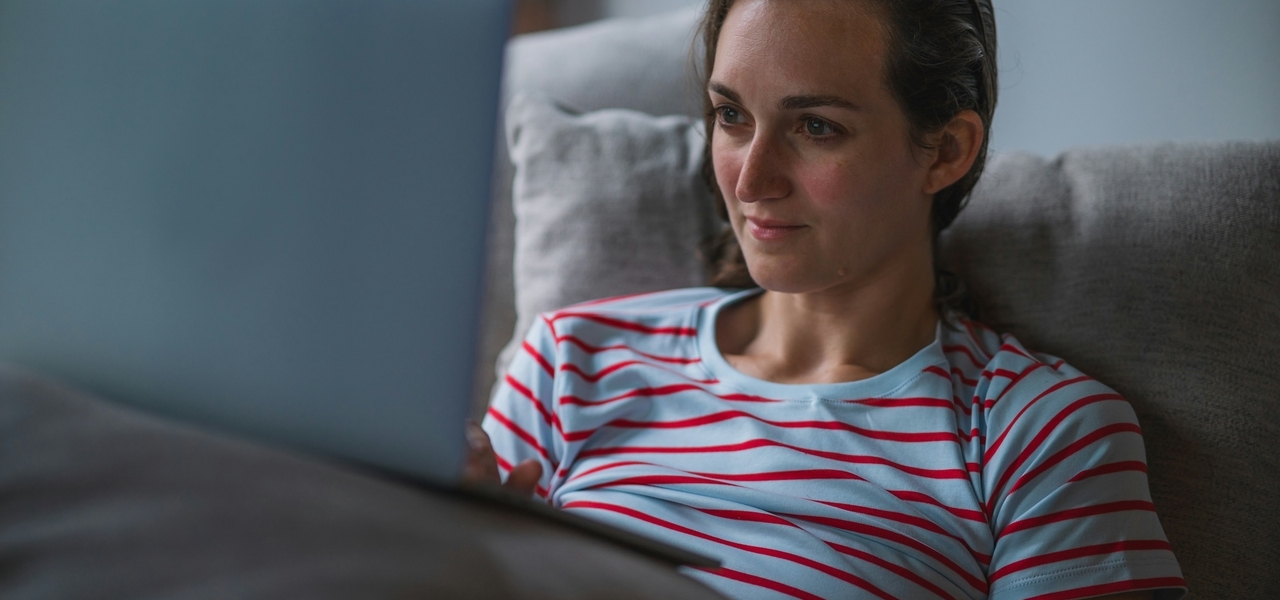 Woman computer laptop bed