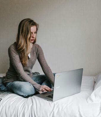 Woman laptop bed