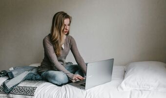 Woman laptop bed