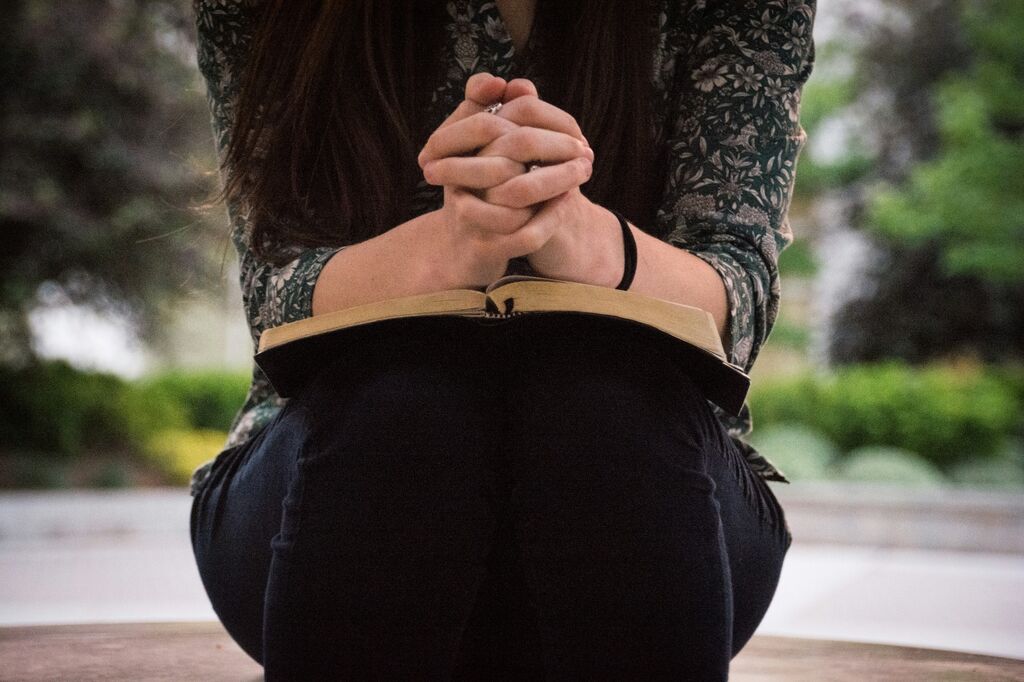 Woman seated bible prayer