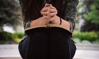 Woman seated bible prayer