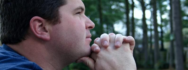 Man praying in woods 2c